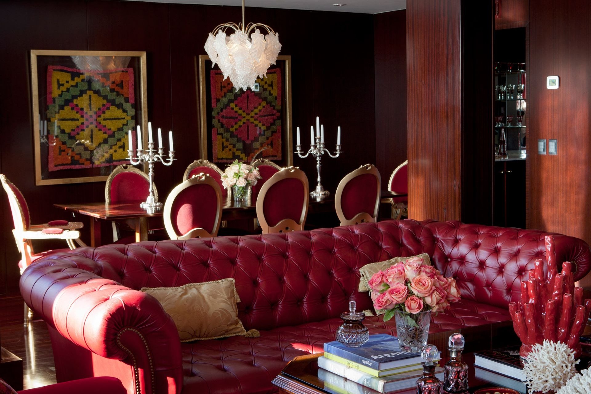 leather couch with dining table behind in hotel presidential suite