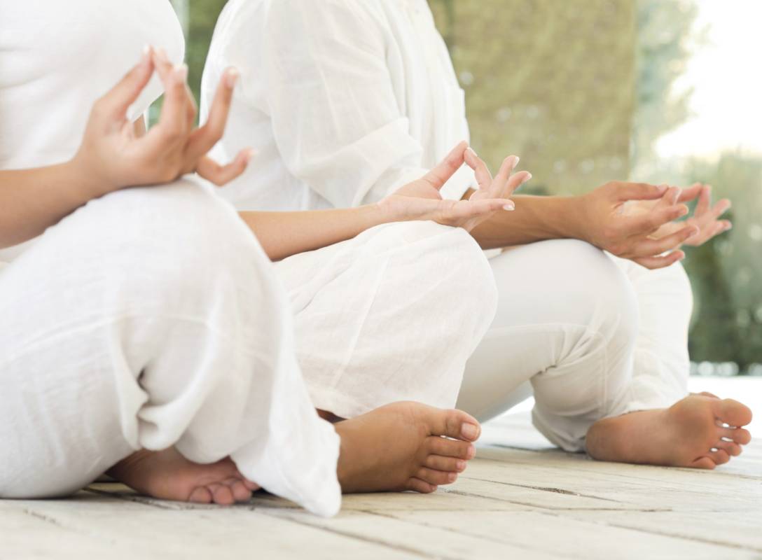 two people sitting in lotus position