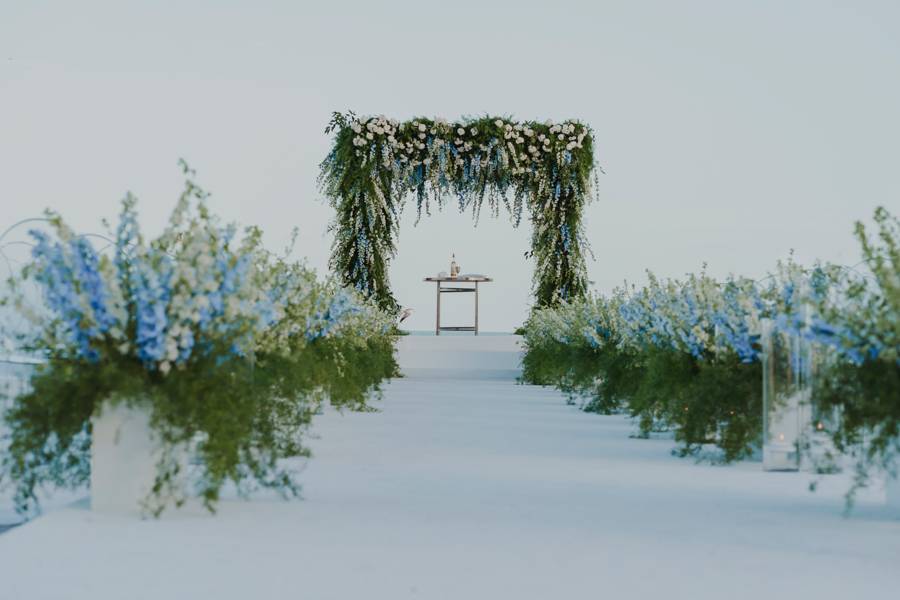 wedding arch made of floral and greenery on beachfront