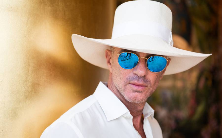 alan faena in sunglasses and a white hat
