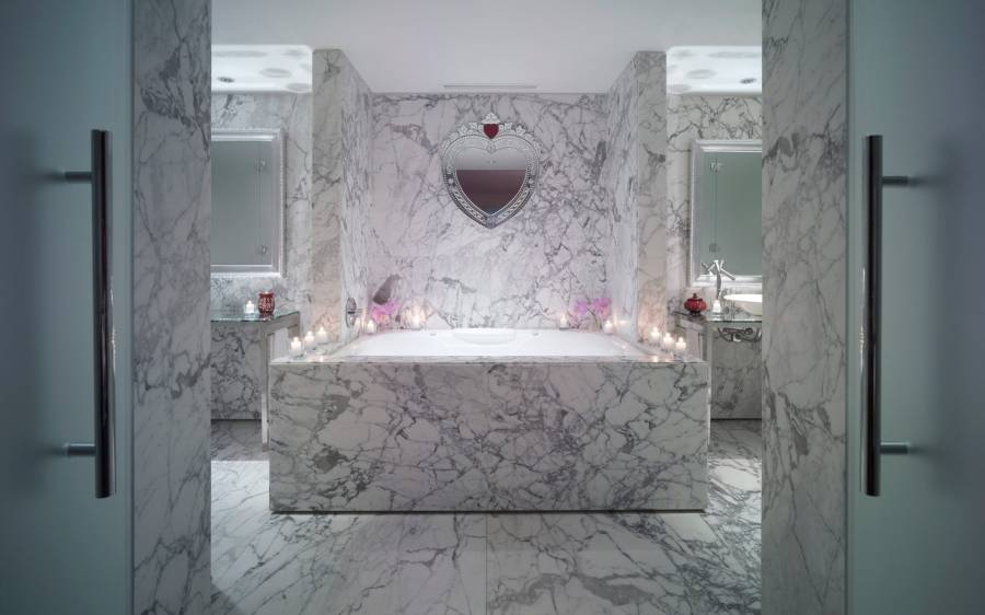 large marble bathtub in hotel suite