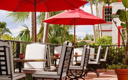 casa faena balcony tables under patio umbrellas