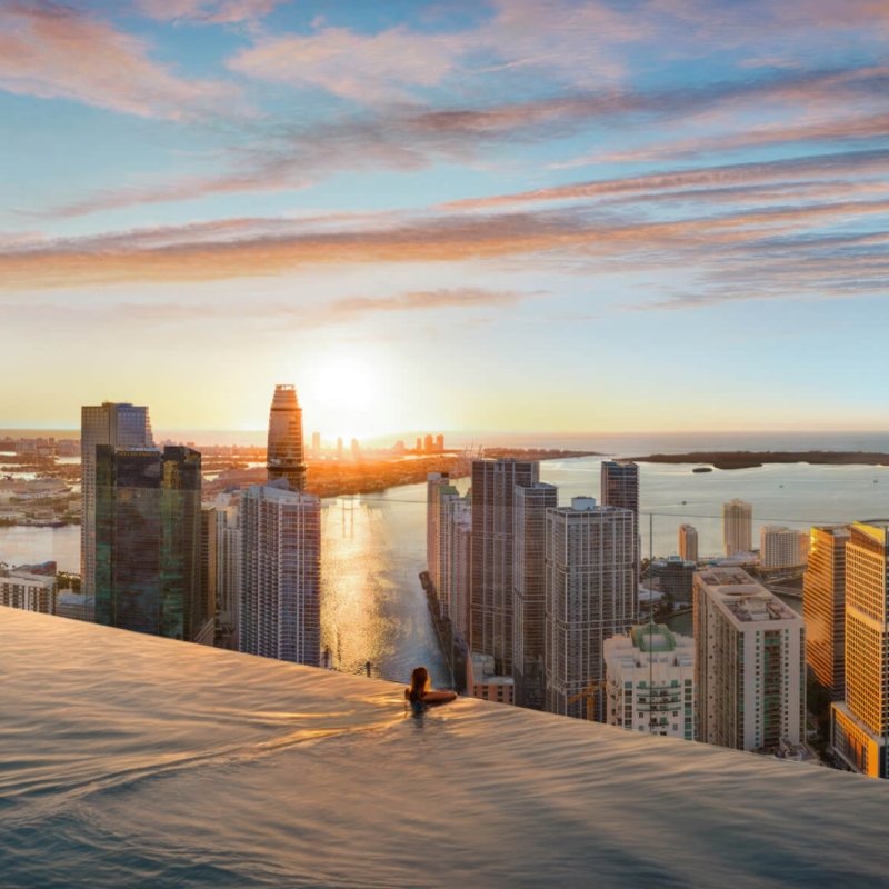 Woman swimming in a pool on the roof of a building