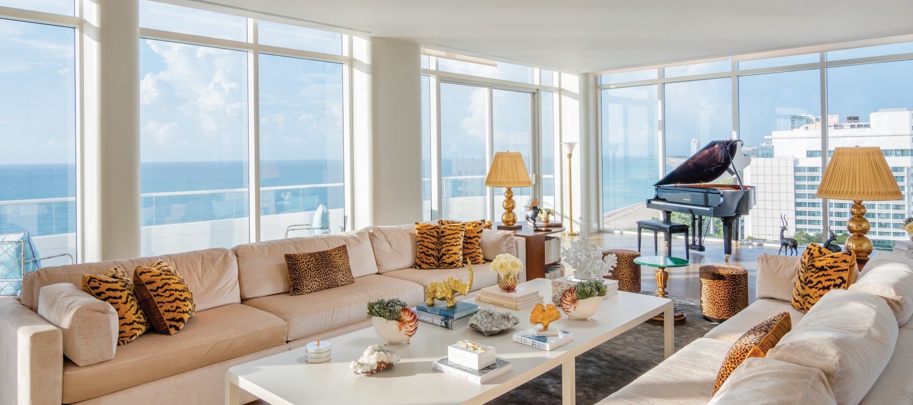 large hotel penthouse with living space and grand piano in the distance
