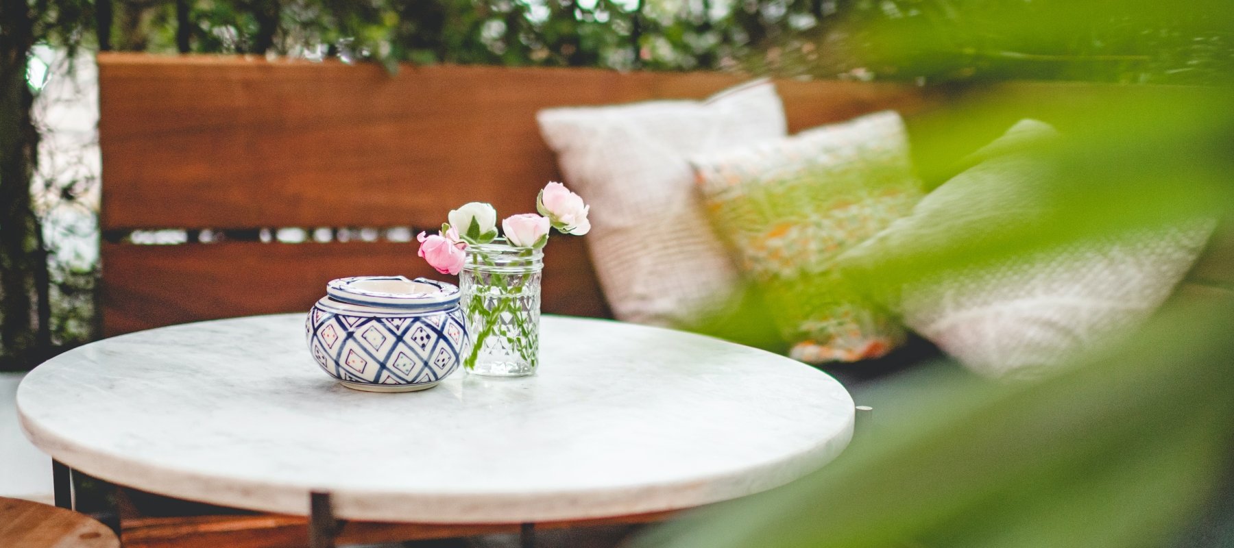 private seating area on patio surrounded by greenery