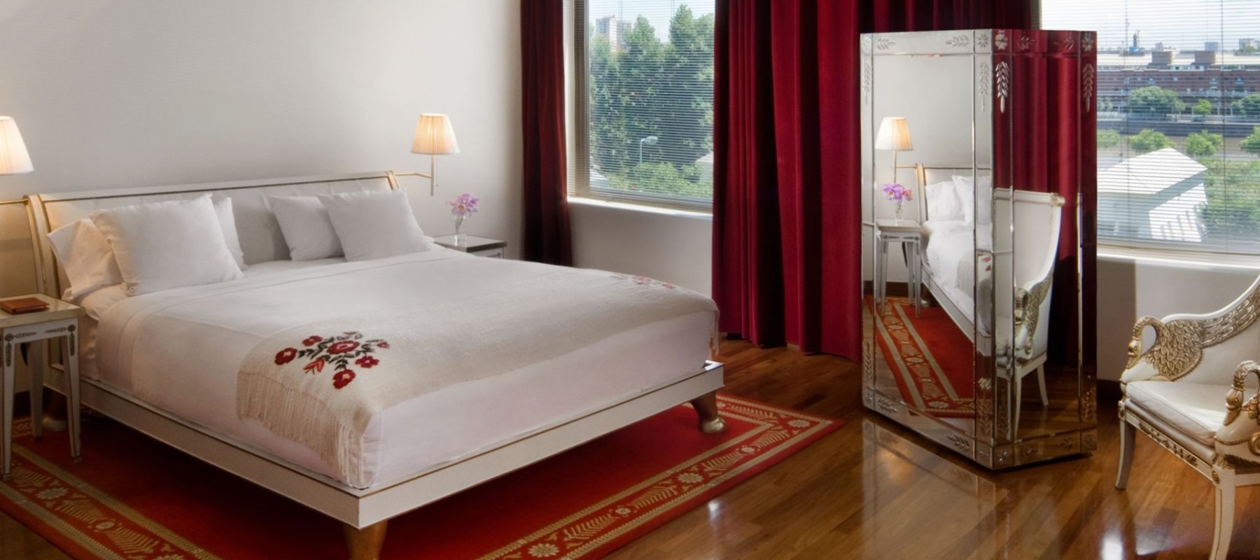 bed in hotel room with large windows