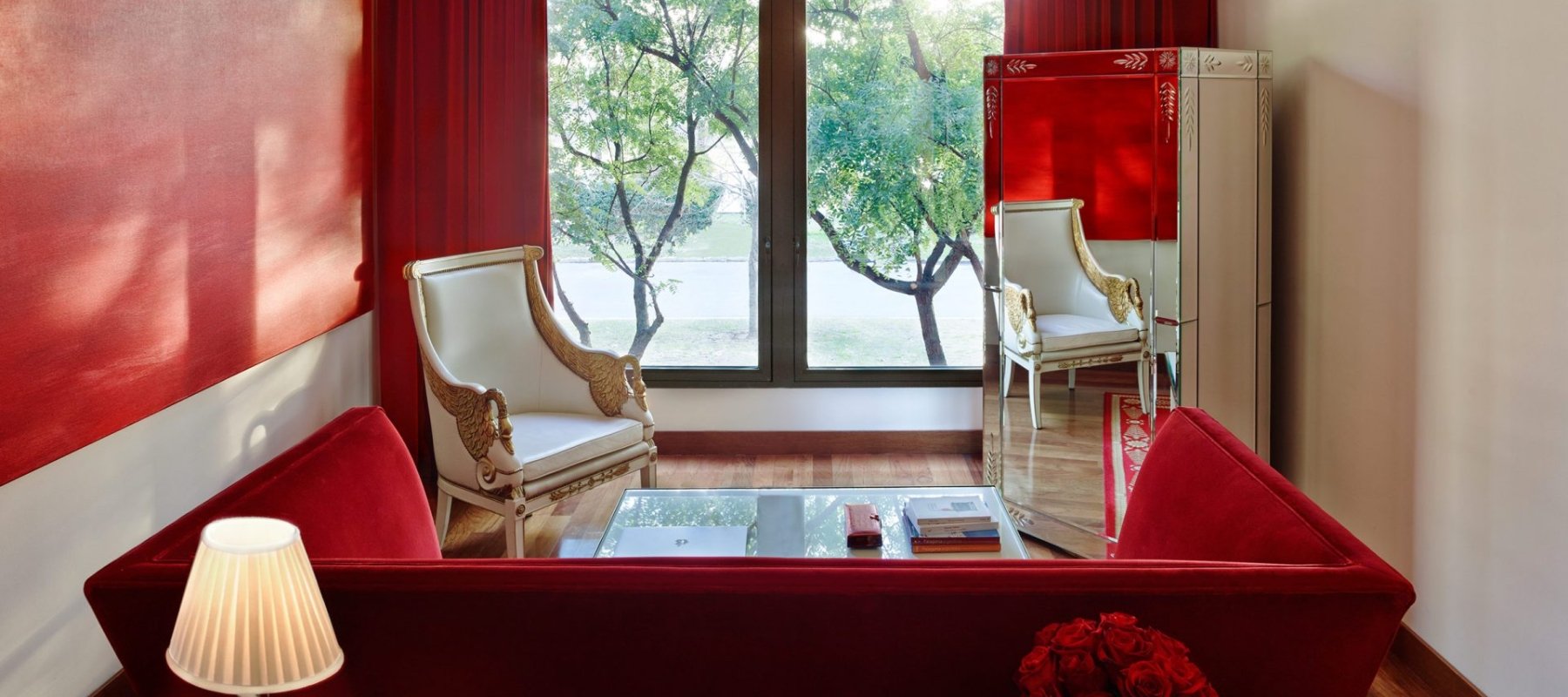 living room with red sofa and large mirror