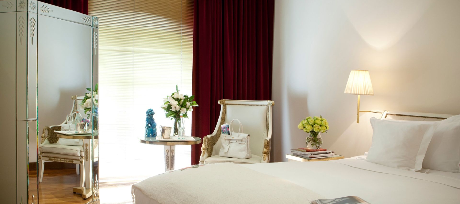 bedroom with small sitting area and large mirror