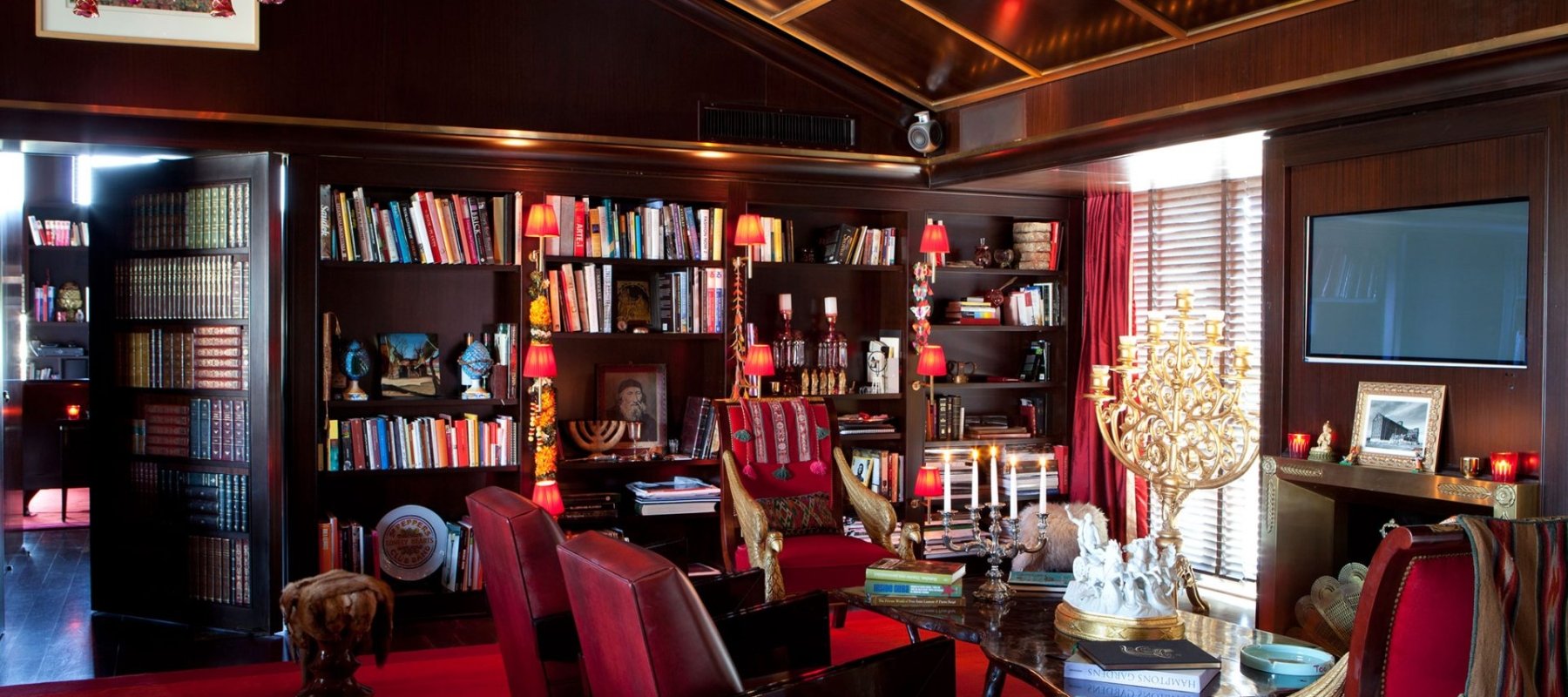Sitting area in Faena Suite with large library on wall