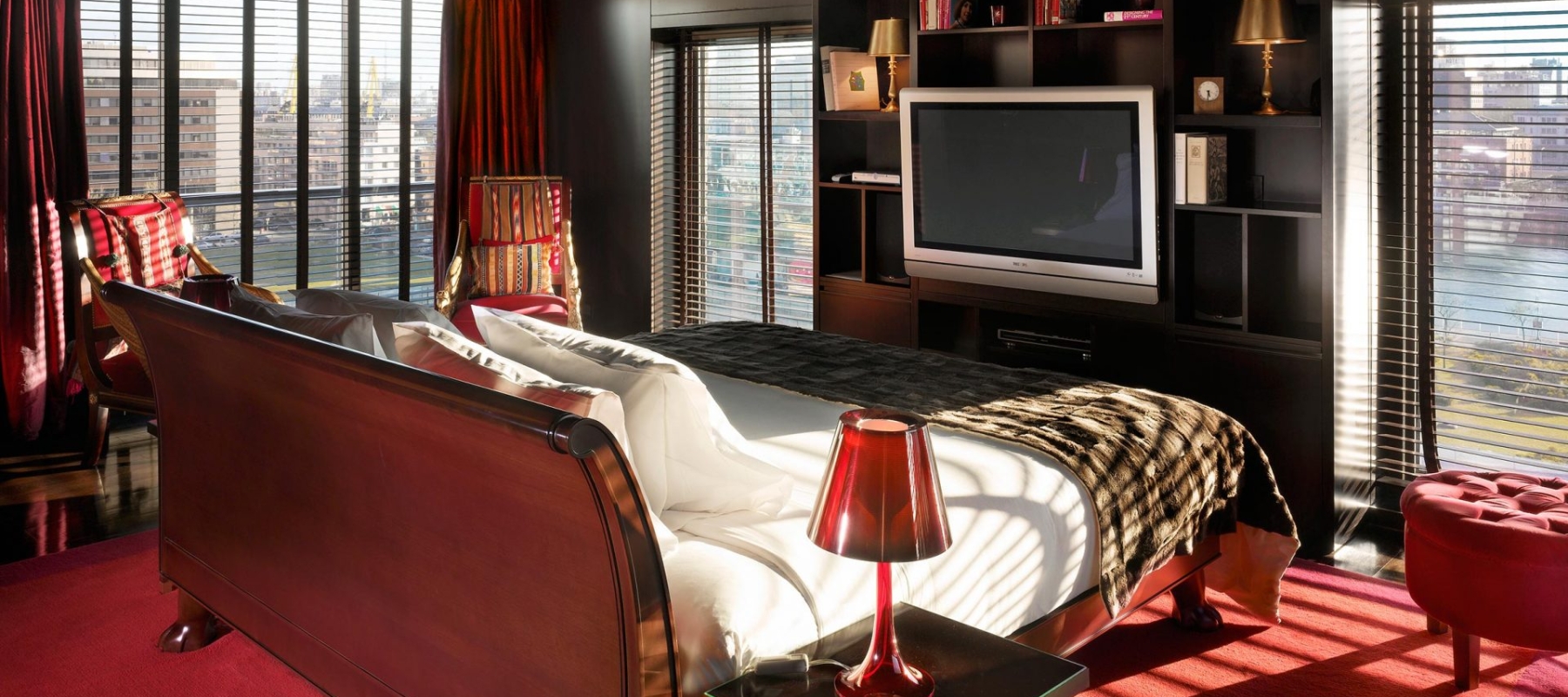 bedroom in the middle of a room facing a television