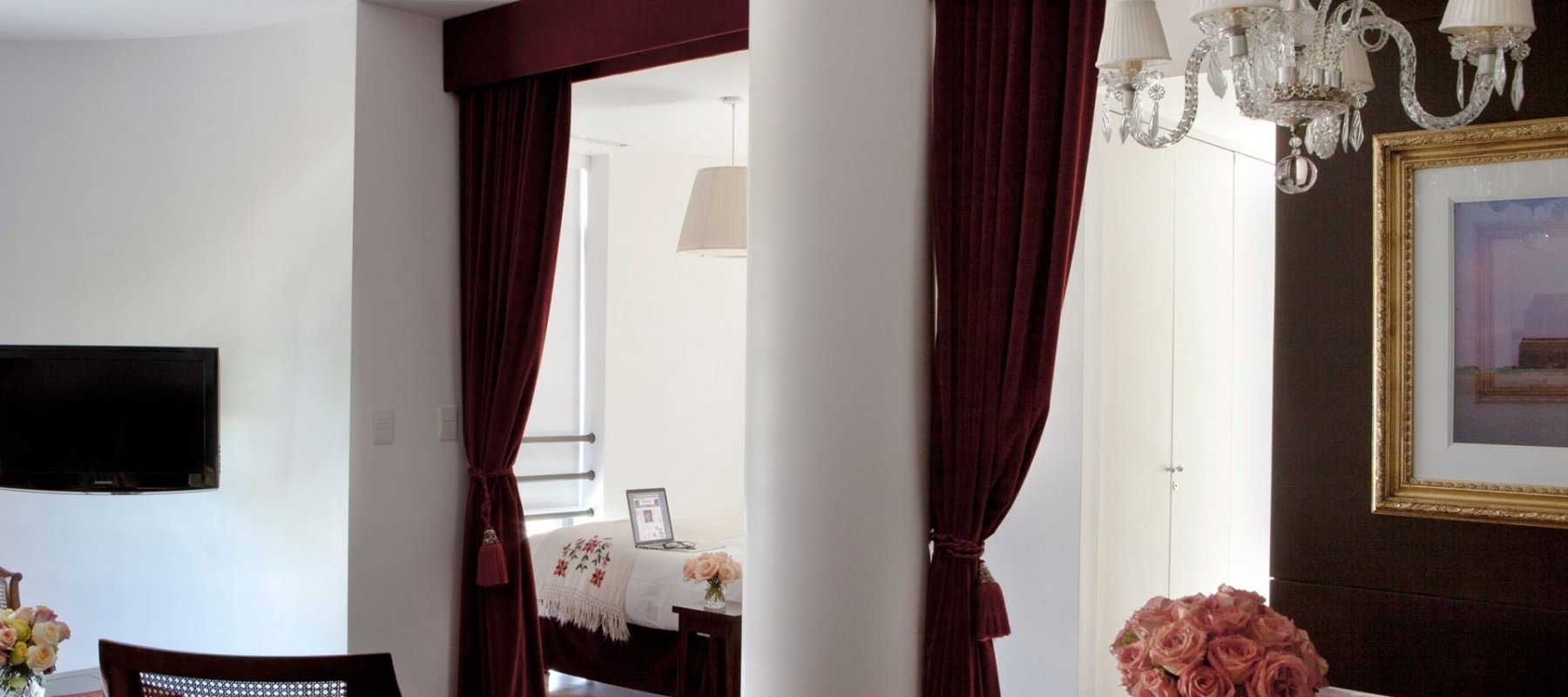 hotel studio room with large column and velvet curtains