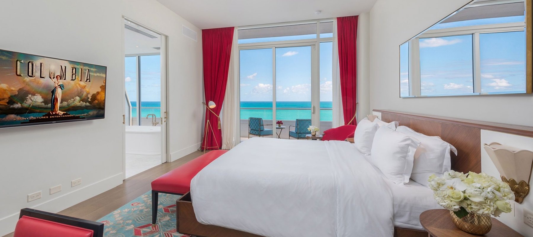 Bedroom with balcony, bathroom, and desk