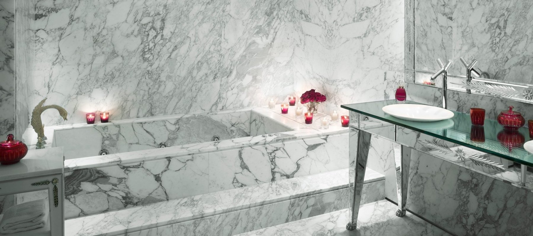 marble bathtub and sink area in hotel suite