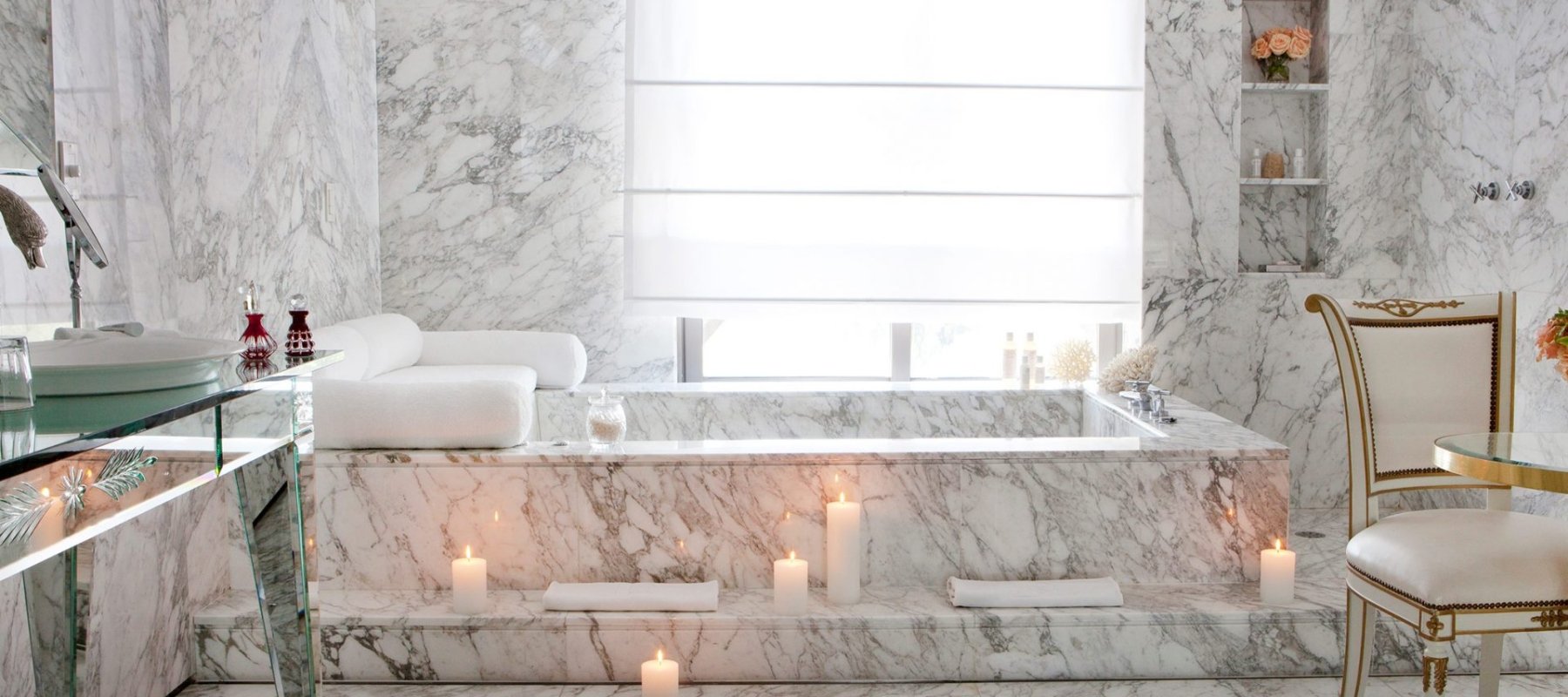bathtub in hotel room lit by candles