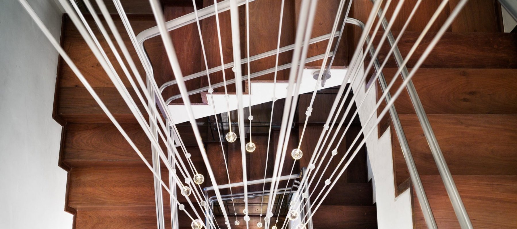looking down a staircase with hanging lightbulbs