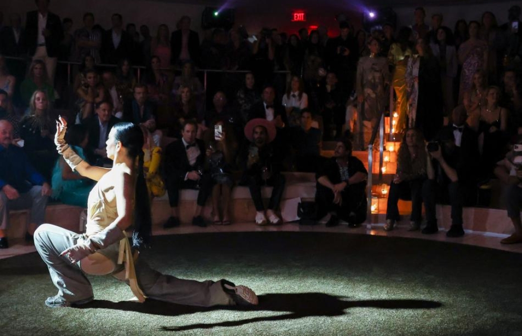 Woman doing a performance before a crowd on the beach