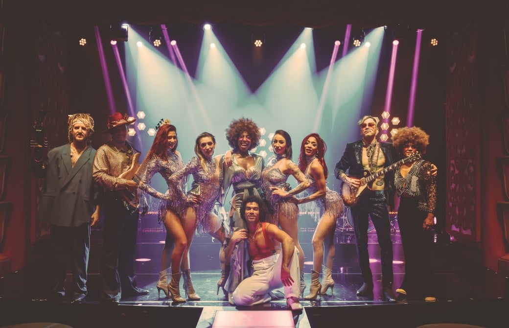A group of dancers posing for a photo after a show