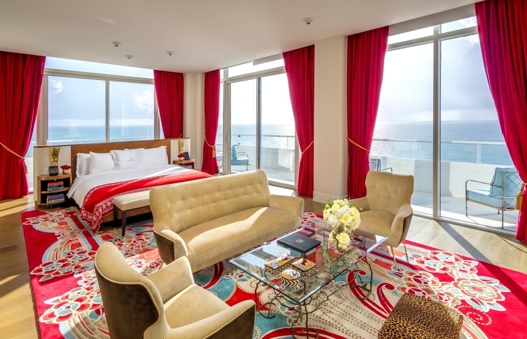 hotel bedroom with sitting area containing couch and two chairs
