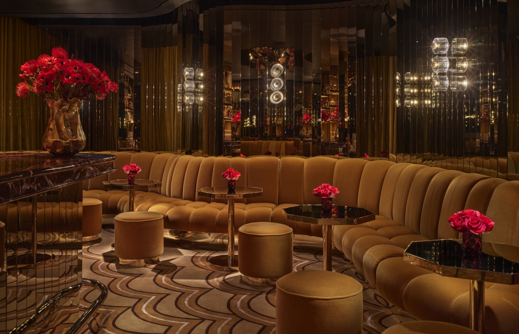 A bar with ample booth seating and gold adornments