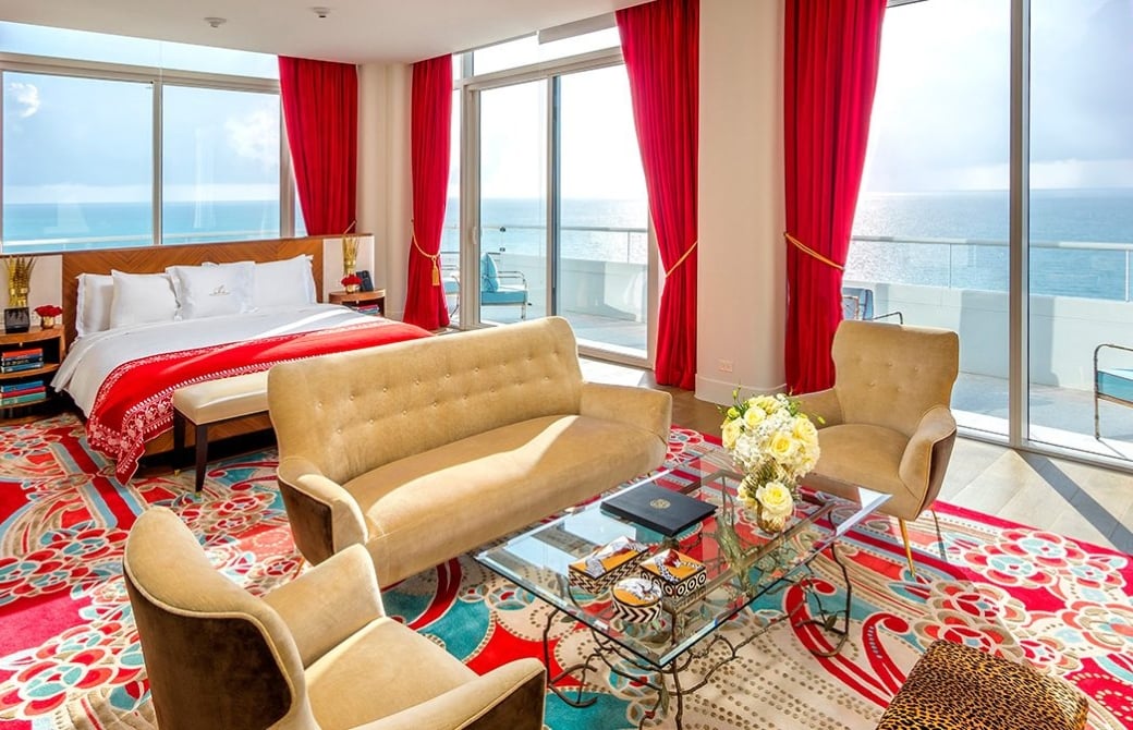 hotel bedroom with sitting area containing couch and two chairs