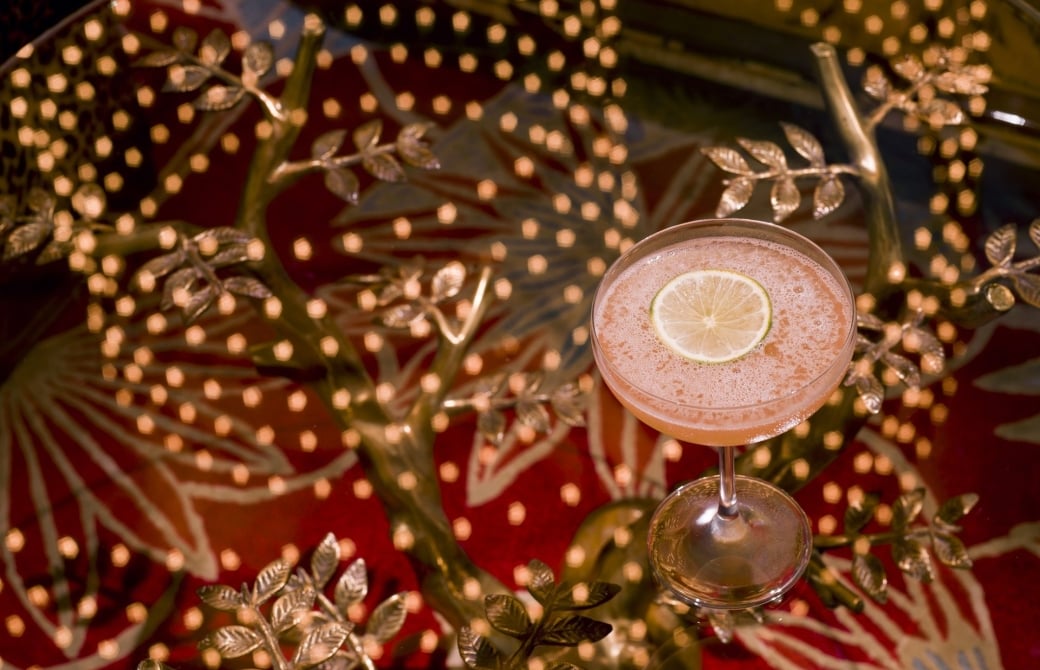 cocktail on glass table which is reflecting the lights