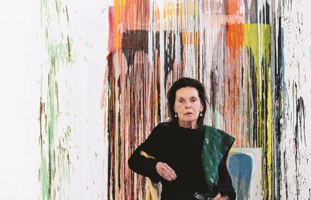 Woman sitting in front of abstract painting