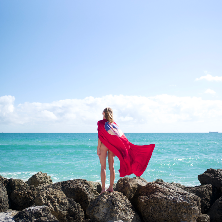 Girl on beach with cape 