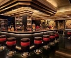 saxony bar interior with red and black stools at the bar
