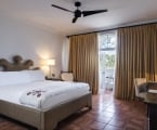 hotel bedroom with large bed and balcony