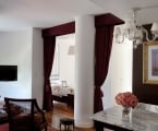 hotel studio room with large column and velvet curtains