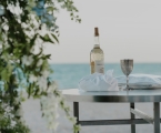 Table on the beach with items for the ceremony.