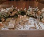 Newly wed diner table with lots of flowers.