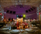 low lit table placement with candles and purple backlit 