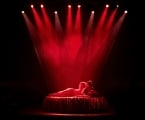 Couple in bed under spotlights