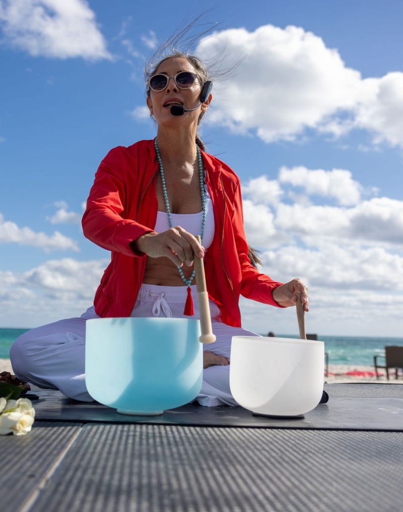 Agustina using sound bowls while leading Hypnotic Full Moon Flow and Meditation