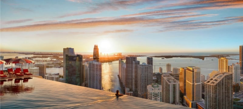 Woman swimming in a pool on the roof of a building