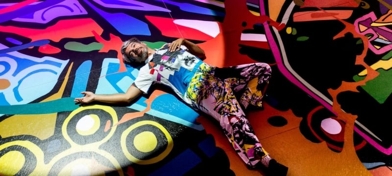 Artist laying down on a mural