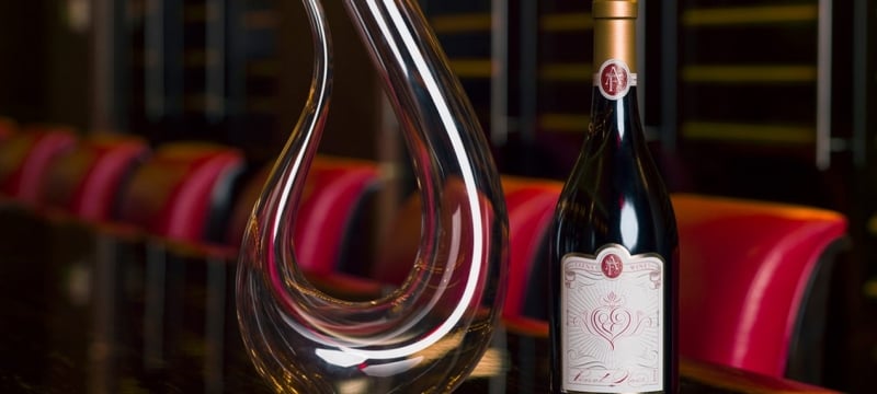 Bottle of wine next to a wine decanter