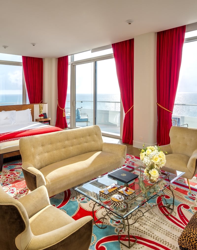 hotel bedroom with sitting area containing couch and two chairs