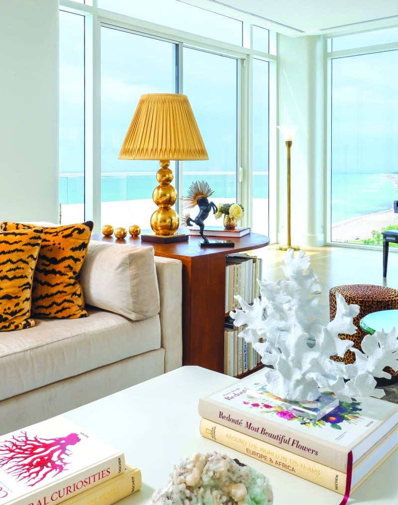 couch in hotel penthouse with grand piano behind