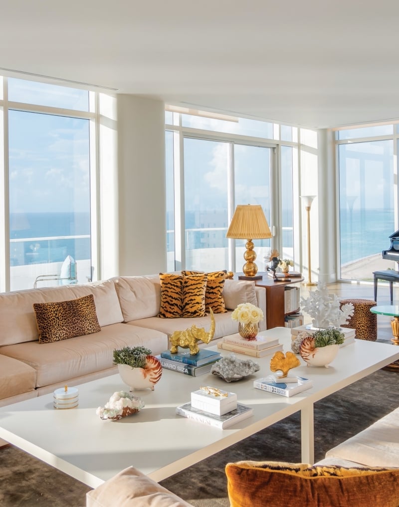 large hotel penthouse with living space and grand piano in the distance