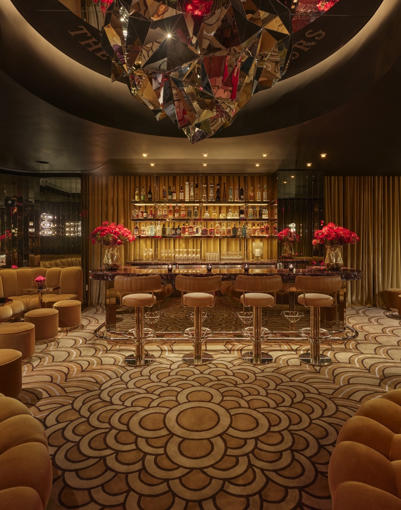 A bar with ample booth seating and gold adornments