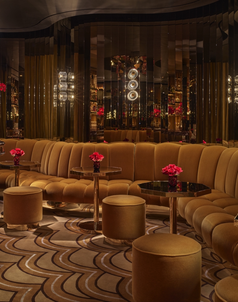A bar with ample booth seating and gold adornments