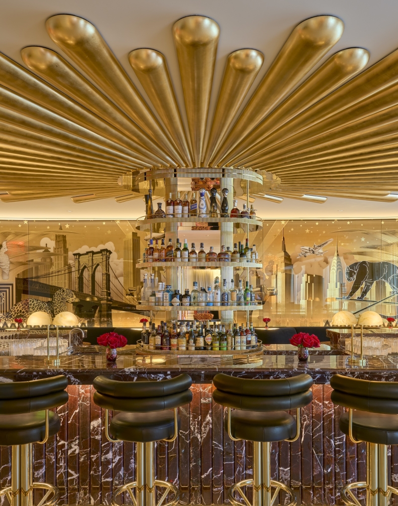 The Living Room, a stylish open bar with gold adornments, at Faena New York