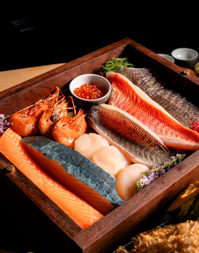 Premium selection of fresh seafood featuring salmon, shrimp, scallops, fish fillets, and salmon roe