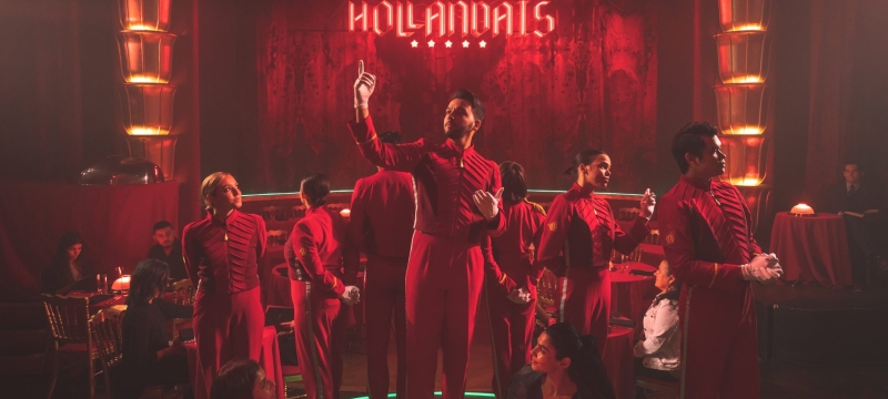 faena theater performers stand in front of stage all wearing red