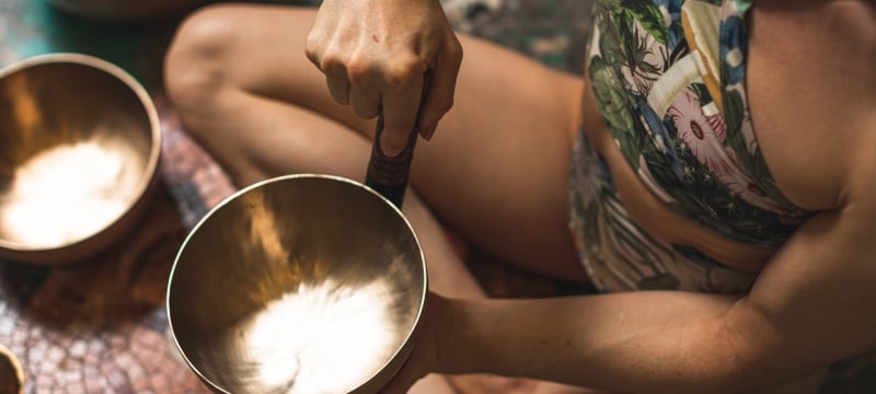 woman holding singing bowl