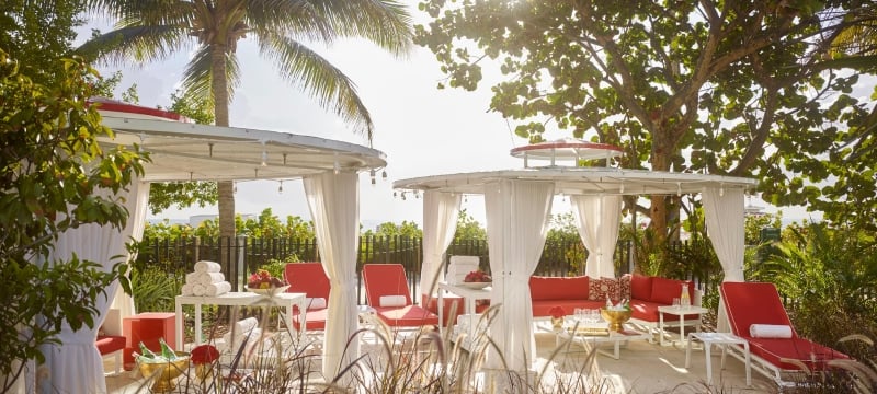 cabanas with red chairs in the sun