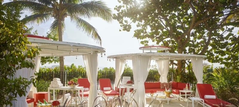 white cabanas with red lounge chairs
