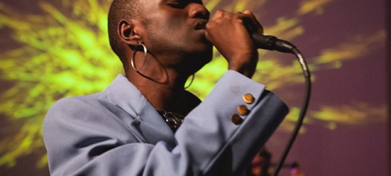 Tama Gucci sings into microphone